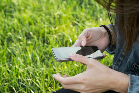 Womans hands using smart phoneの写真素材
