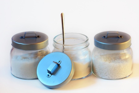 three jars of sugar and salt with white backgroundの写真素材