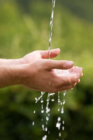Water is falling into the handsの写真素材