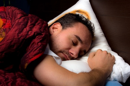 youg man is sleeping into the bedの写真素材