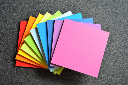 bright colors of the rainbow square plate against a dark background close-up