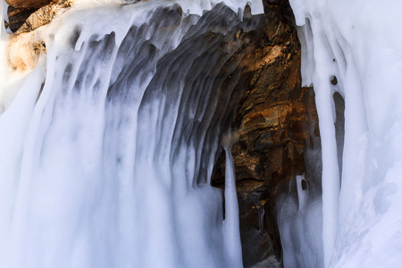 A small stone grotto with frozen waves on lake Baikal.の写真素材