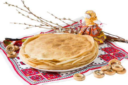 Background with pancakes, textile doll and pussy-willow isolated on white for Maslenitsa festival. Traditional Russian meal for Shrovetide.の写真素材