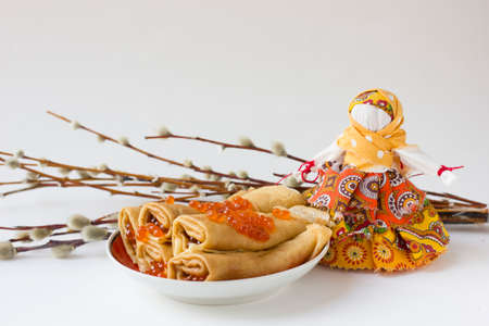 Background with pancakes, caviar, textile doll and pussy-willow isolated on white for Maslenitsa festival.の素材 [FY310181767876]