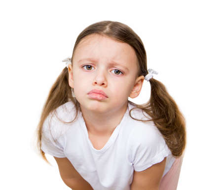 Sad caucasian cute little girl in white t-shirt isolated on white background. Upset baby girl.
