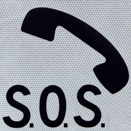 Symbol of a phone and word SOS on a white backgroundの写真素材
