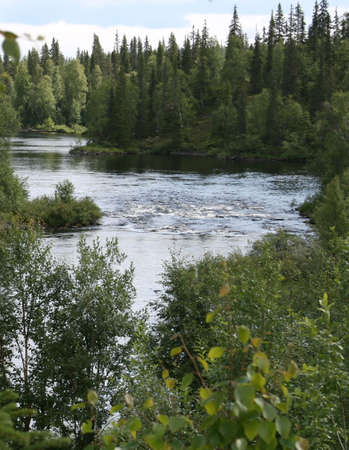 The river Krasnenkaja on Kola peninsula Russia. In the middle of the river a small threshold with...