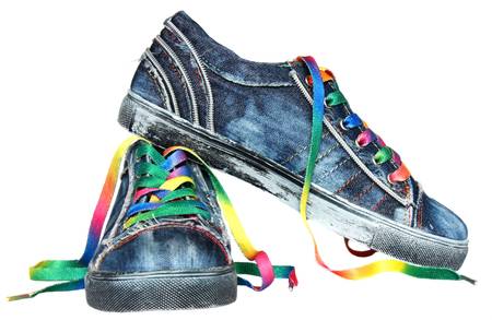 Pair of blue sneakers with bright laces isolated on whiteの写真素材