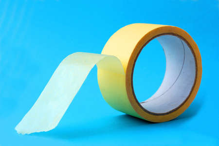 Building tape yellow on blue backgroundの写真素材