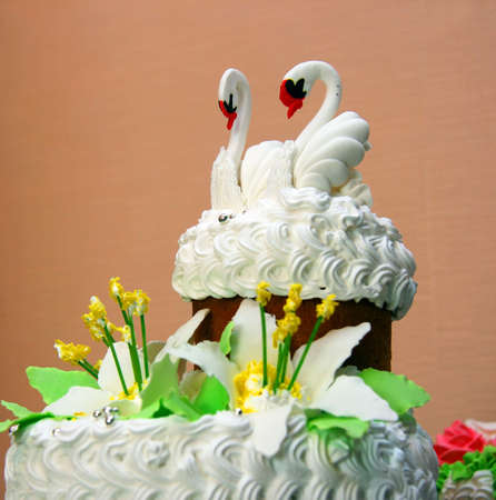 The upper part of the traditional wedding cake with figures of two swansの写真素材
