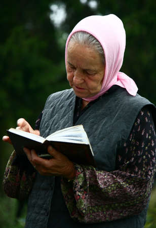 Older women reading book in parkの写真素材
