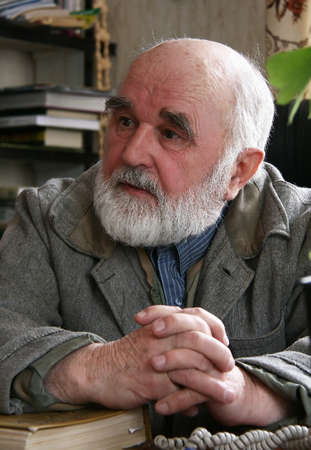 Bald man with a beard sitting at the table