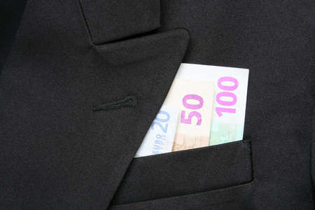 Money in a breast pocket of a jacketの写真素材