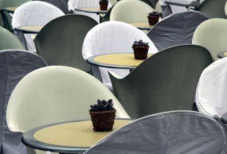 White little tables of summer cafe with flower flowerpots in the Swiss city. の写真素材