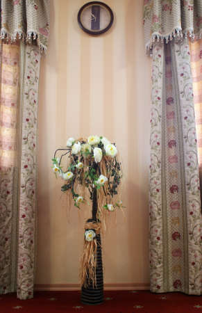 Bouquet of beautiful flowers in the vase near the windowの写真素材