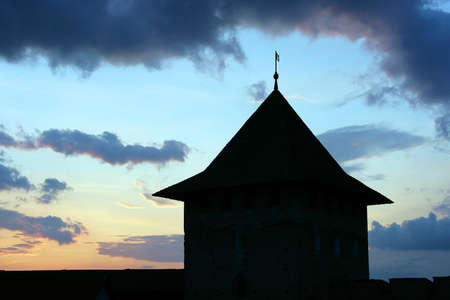Medieval tower in silhouette at sunsetの写真素材