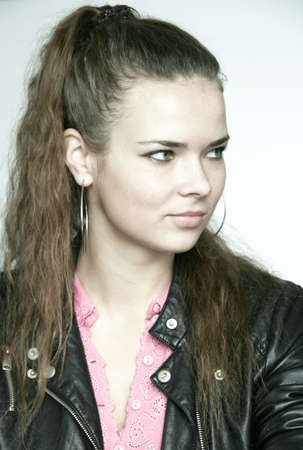 Portrait of pretty young woman with hands under chin and smilingの写真素材