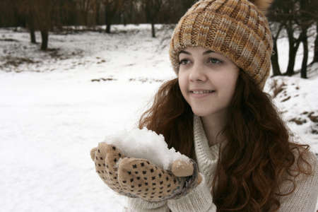 Beautiful winter woman with snow