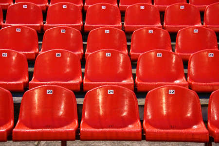 Wet bright red stadium seats after rainの写真素材