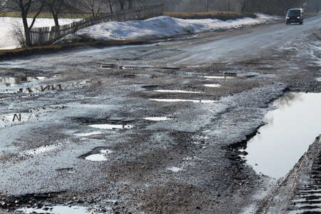 Puddles in the pits in the road.