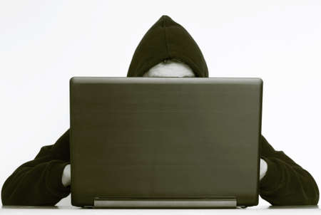 Hacker writing on a laptop and data safetyの写真素材