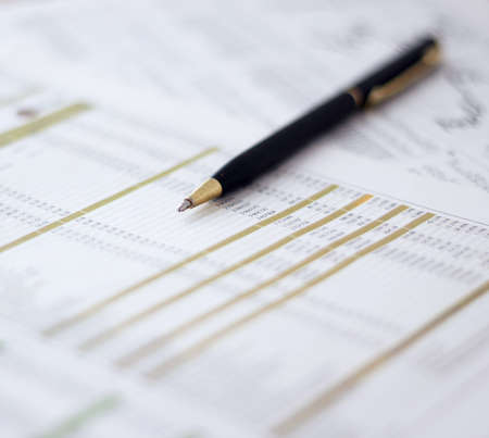 Close-up of metallic pen on document at workplace  Shallow depth of field の写真素材