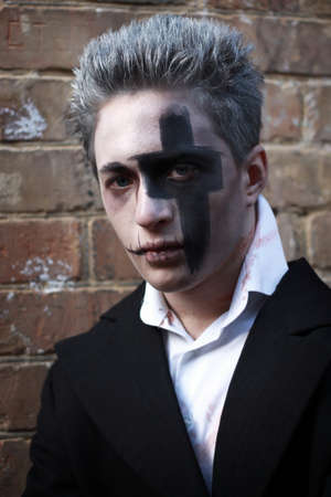 LUTSK - NOVEMBER 1: Portrait of a make-up man with his mouth sewn up in a bloody shirt at Halloween on November 1, 2013 in Lutsk, Ukraine.のeditorial素材