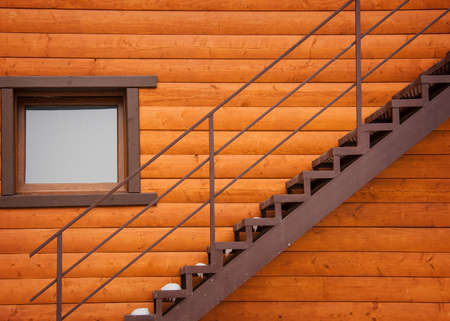 Metal stairs and window home with wooden beamsの写真素材