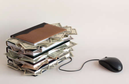 Computer mouse and notebook with moneyの写真素材