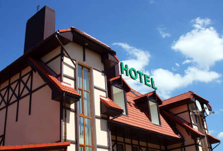 The facade and the roof covered with tiles of the hotel signboardのeditorial素材