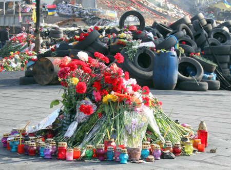 KIEV, UKRAINE - MARCH 7, 2014: Ukrainian revolution, Euromaidan. Days of national mourning for killed defenders of Euromaidan. Flowers and lighted lamps on barricades defenders of Euromaidanのeditorial素材