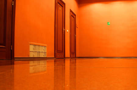 The doors in an empty corridor, walls and a ceiling of orange colorの写真素材