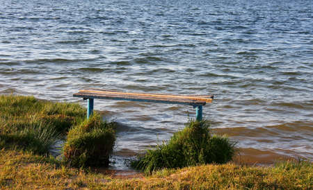 Empty bench overlooking a lake