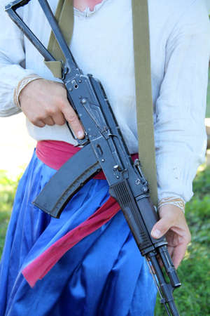 Man in Ukrainian linen shirt and trousers with rifle AK-47