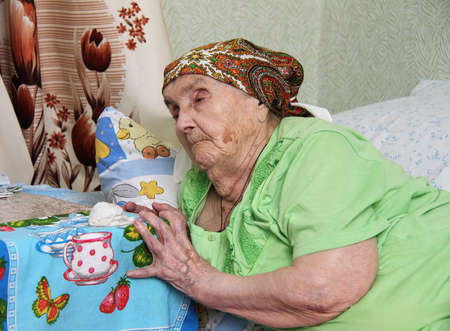 ROKYTNE, UKRAINE - AUGUST 05 - A blind woman lying on the bed at home in Rokytne on August 05, 2014. のeditorial素材
