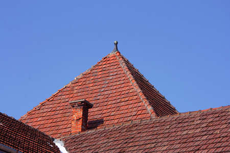 Old roof tile over blue sky