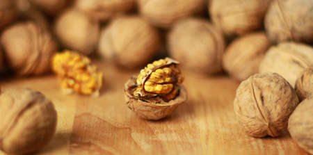 Walnut kernels and whole walnuts. Shallow depth of field.