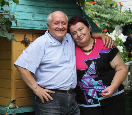 ROKYTNE, UKRAINE - 05 AUGUST 2014: Happy senior couple relaxing in garden on August 05, 2014 in Rokytne, Ukraine.のeditorial素材