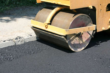 Compactor roller during road construction at asphalting work