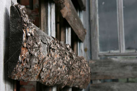 Boarded-up window in an abandoned old building. Shallow depth of field.
