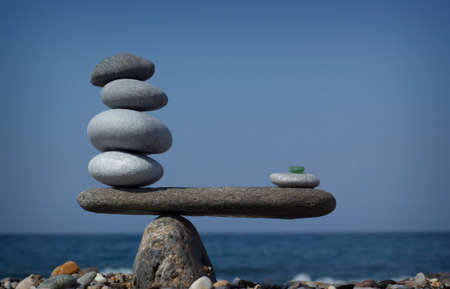 Symbol scales is made of stones of various shapesの写真素材