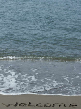 Welcome written in a sandy beachの写真素材