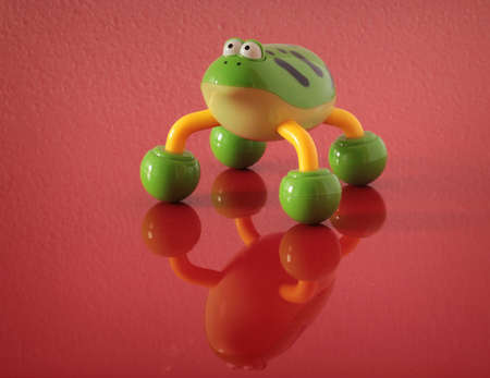 Plastic toy frog standing at the table.の写真素材