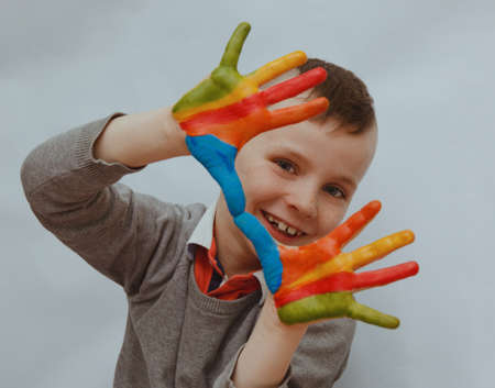 Portrait of a little boy enjoying his paintingの写真素材