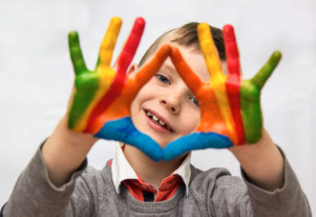 Portrait of a little boy enjoying his paintingの写真素材