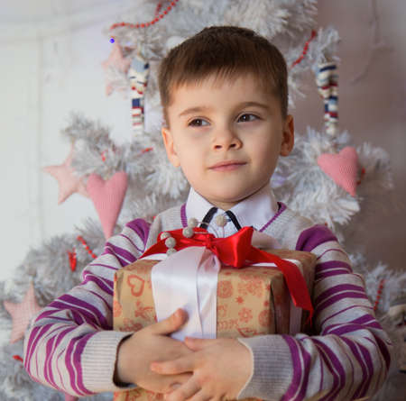 Boy with Christmas gift. Shallow depth of field.の写真素材