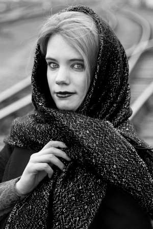 Young caucasian woman with a scarf on her head in a autumnの写真素材