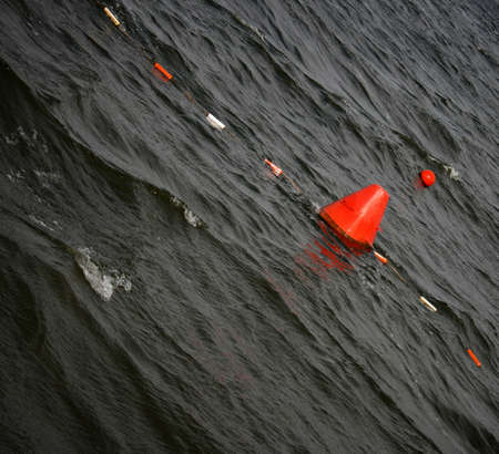 Floating red navigational buoy on lakeの写真素材