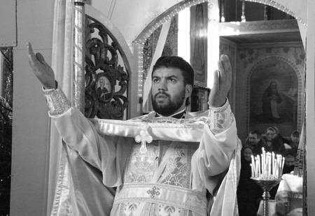 VOYUTYN, UKRAINE - JANUARY 08: Orthodox priest during Christmas service in Voyutyn on January 08, 2009.のeditorial素材