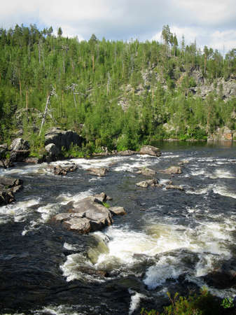 Landscape with mountains forest and a river in frontの写真素材